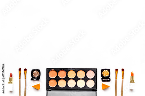 Professional bulk cosmetics pattern. Eyeshadows, rouge, brushes on white background top view copyspace