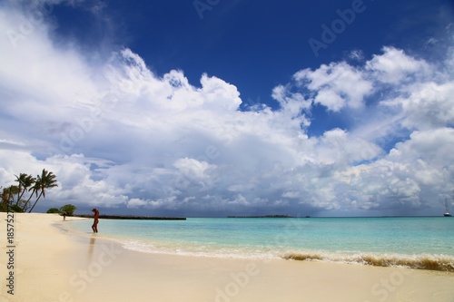 panorama of a tropical beach and a girl in the distance