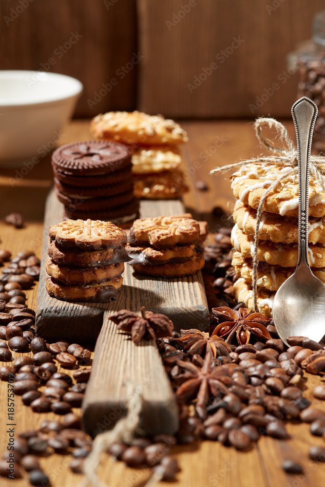 Aroma coffee candy chocolate cookies and spices on the wooden table. Christmas sweets. Dark wooden background. Top view. Close. Closeup.