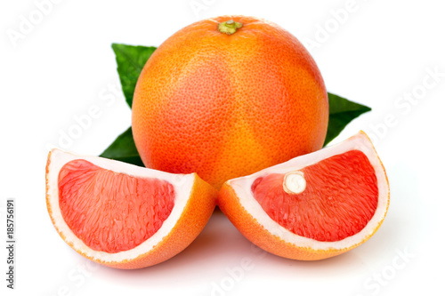 Pink grapefruits with green leaves isolated on white background