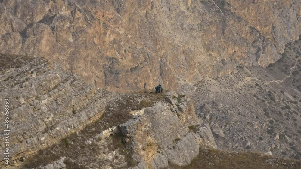 Photographer on the background pattern of the rocks Photographer on the background pattern of the rocks