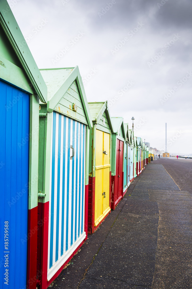 Naklejka premium Colourful Beach Huts on Dull, Drab, Cloudy Winters Day in Brighton, West Sussex, England, UK