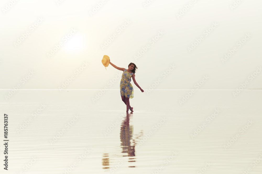 Woman relaxing at the beach with arms open enjoying her freedom Woman relaxing at the beach with arms open enjoying her freedom