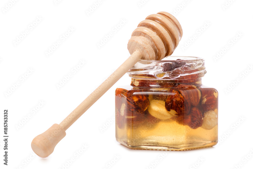 A honey jar with a spoon for honey nuts A honey jar with a spoon for honey nuts