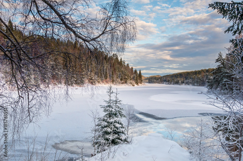 View over the cold snowy lake in evening light © Terje