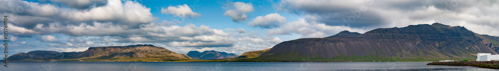 Large panorama in Iceland with mountains and cloud sky