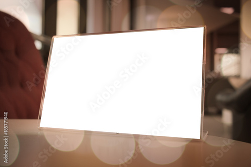 Mock up white Label for blank menu frame in Bar restaurant cafe., Stand for booklets with sheets paper tent card on table cafeteria, blurred background insert for text of customer. Space for texting.