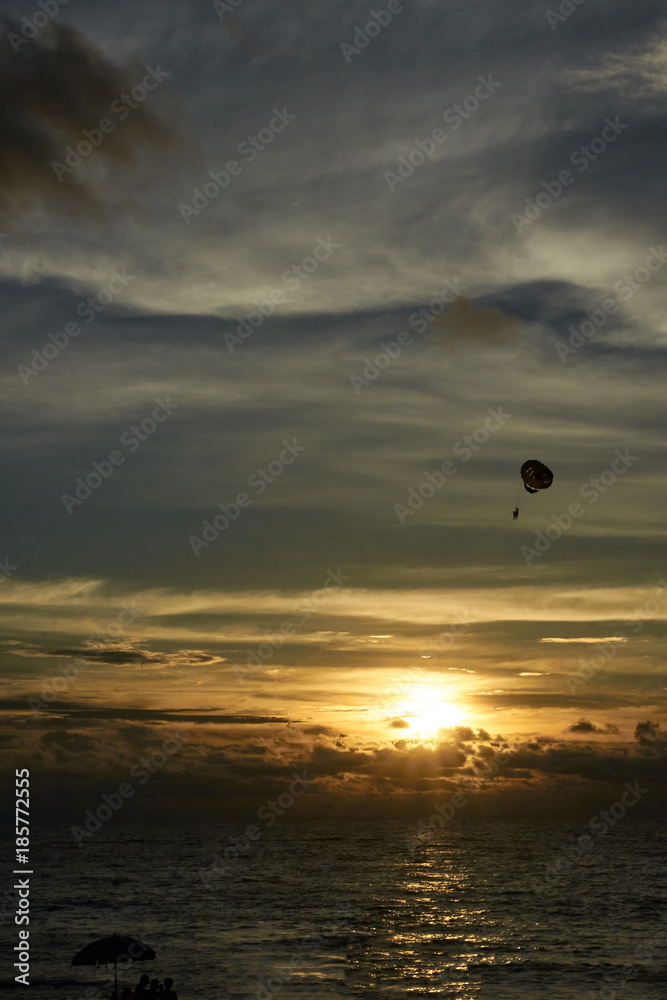 Parachute. Free flight. Sunset at sea Parachute. Free flight. Sunset at sea