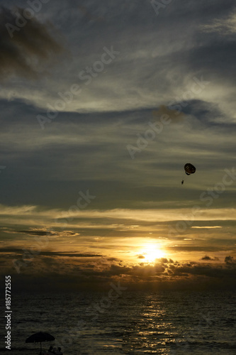 Parachute. Free flight. Sunset at sea