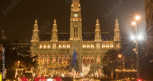VIENNA, AUSTRIA – DECEMBER 2015 : Timelapse of Rathaus / City Hall at night with christmas lights people and traffic