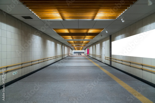 Walkway with Blank billboard located in underground hall or subway for advertising, mockup concept, Low light speed shutter