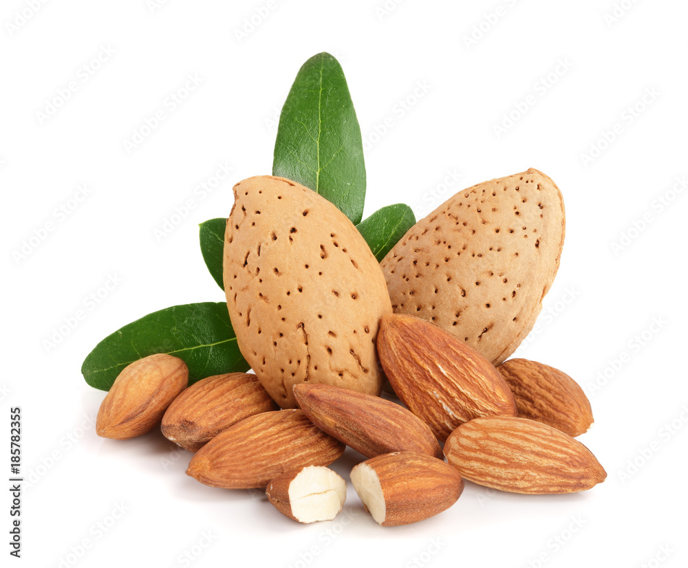 Group of almond nuts with leaves isolated on white background