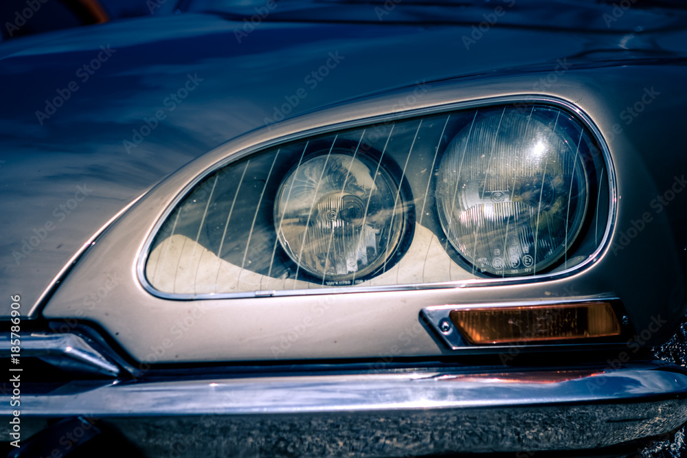 Close-up, detailed photo of the front, grille and head lamp of a classic oldtimer car