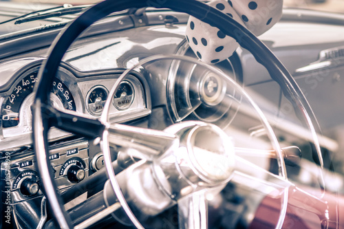 Close-up, detailed photo of the interior, dashboard steering wheel and speedometer of a classic oldtimer car