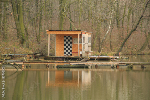 bizzare post-apo looking cottage with narrow catwalk on Hermanicky pond, Czech Republic photo