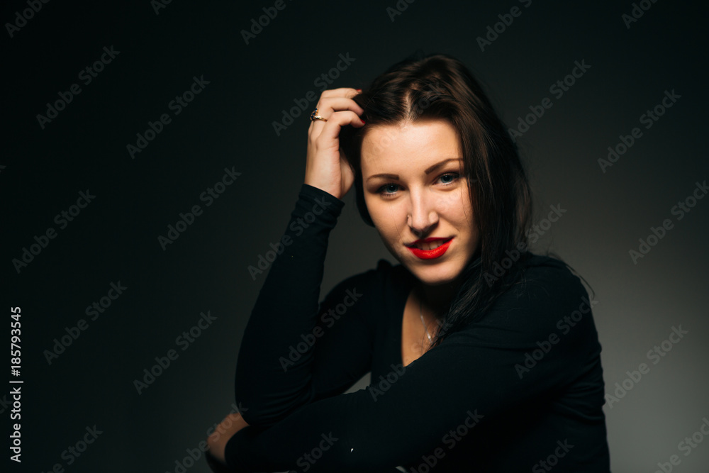 emotional girl smiling on a dark background emotional girl smiling on a dark background
