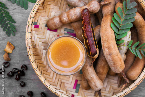 Tamarind and tamarind juice with honey on wooden background