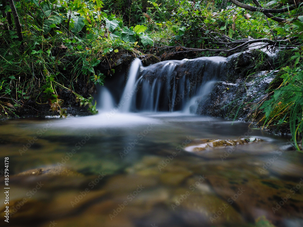 Waterfall at the carpatian mountains green forest