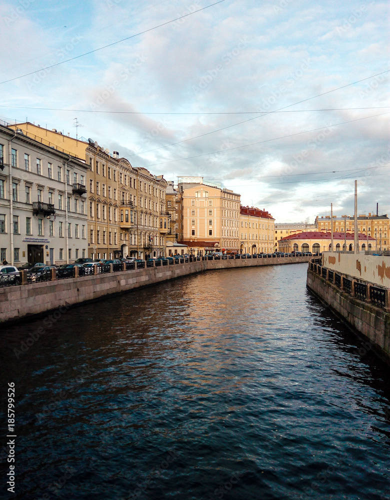 street view of St. Petersburg in the historical part of the city. the same river can be seen.