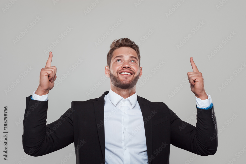 Content businessman pointing up