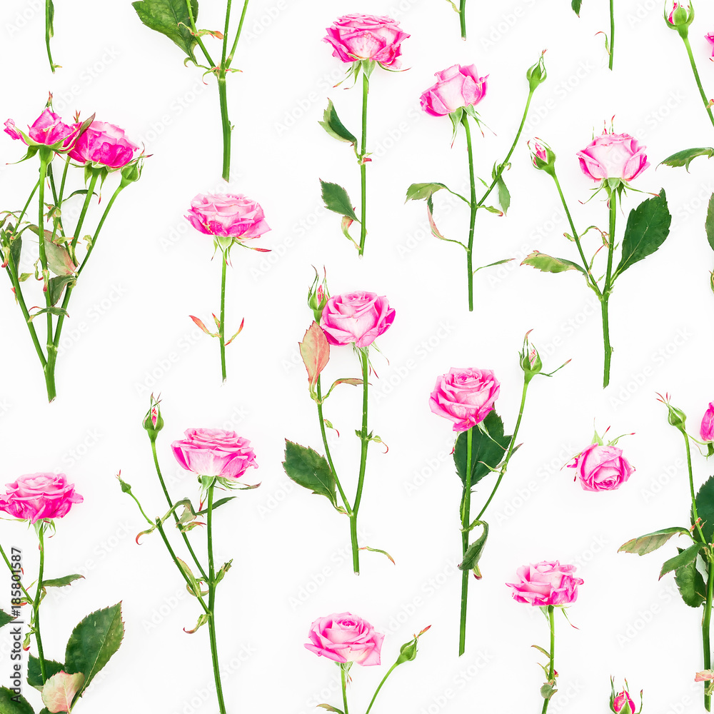 Floral pattern with pink roses, branches and leaves on white background. Roses flower texture. Flat lay, Top view.