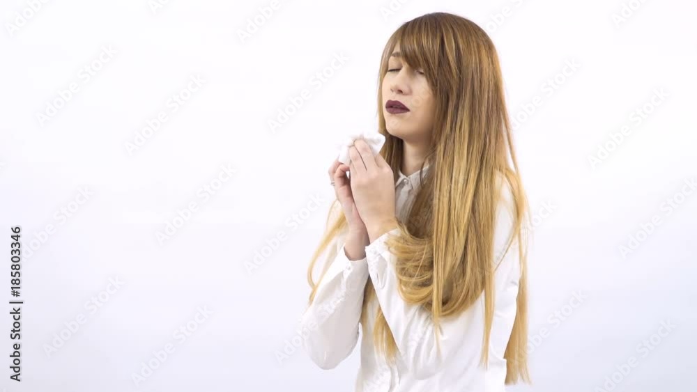 Beautiful sick girl sneezing at white background Beautiful sick girl sneezing at white background