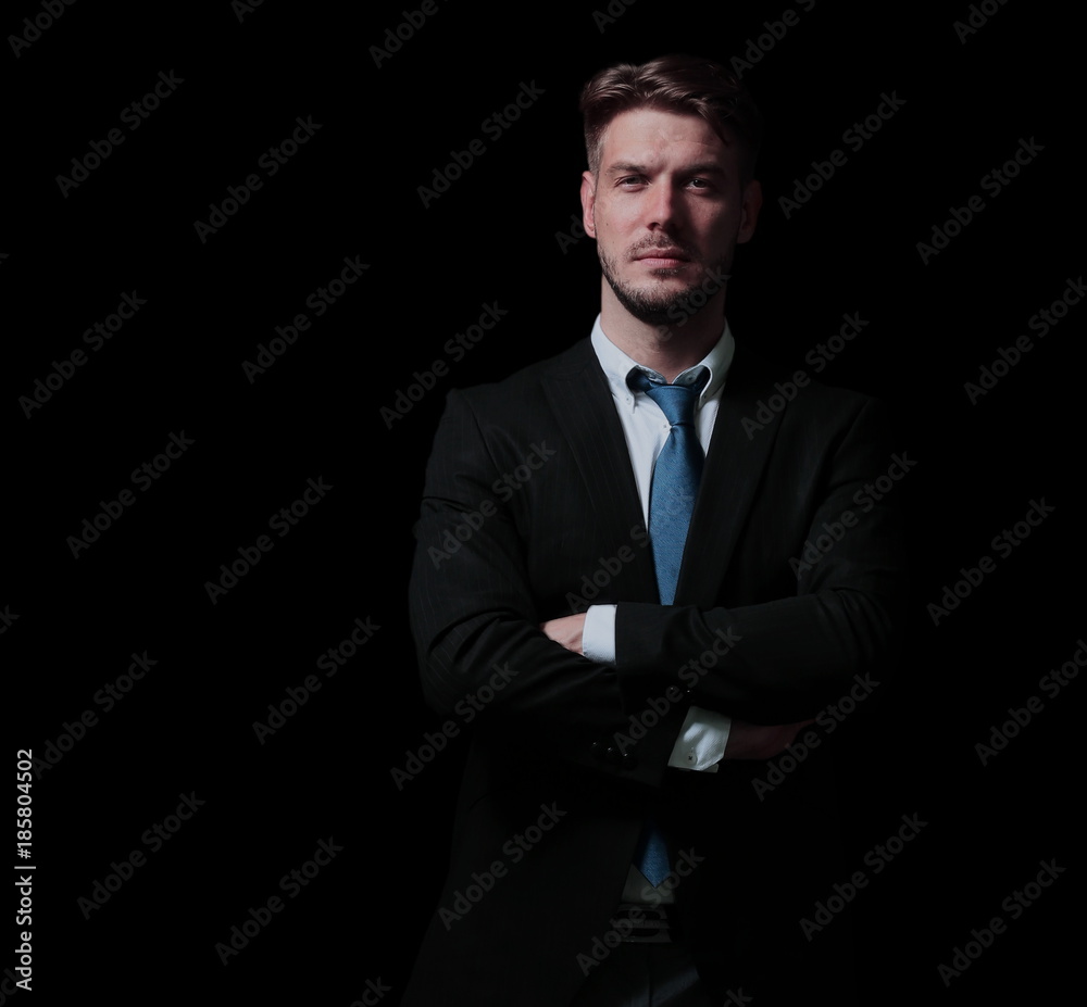 Handsome business man isolated on black with arms crossed Handsome business man isolated on black with arms crossed