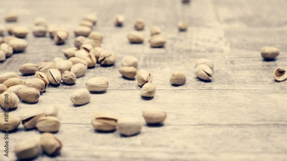 Pistachios on wooden background in studio. Healthy delicious snacks Pistachios on wooden background in studio. Healthy delicious snacks