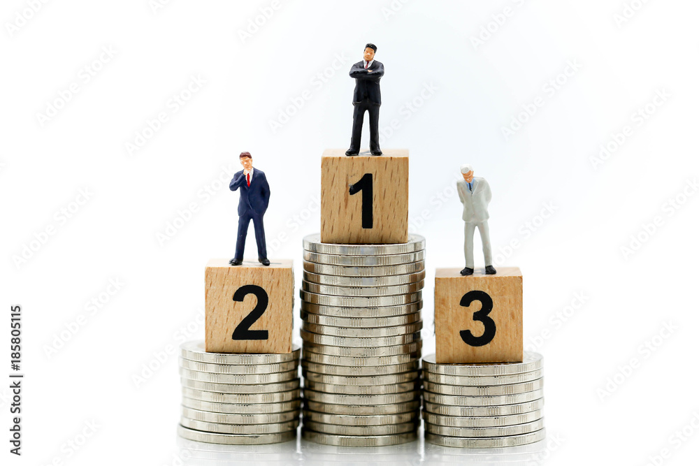 miniature people : businessmen standing on wooden number 1,2,3 block.Achievement and business concept. miniature people : businessmen standing on wooden number 1,2,3 block.Achievement and business concept.