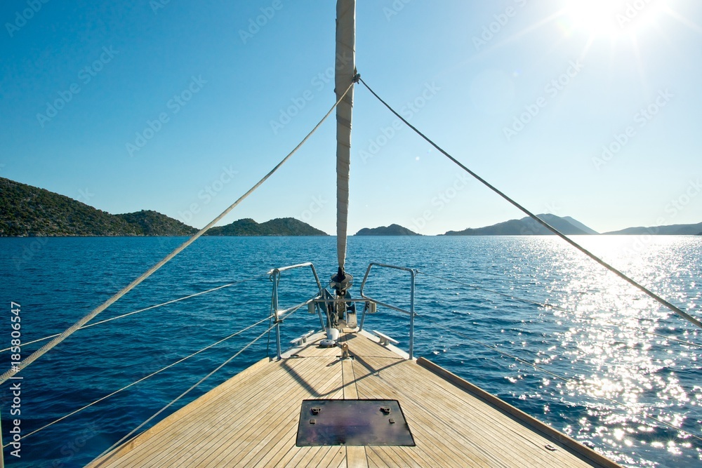 Fototapeta premium Front deck of a sailing yacht with beautiful sea and islands in the background.