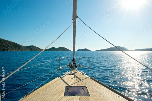 Front deck of a sailing yacht with beautiful sea and islands in the background.