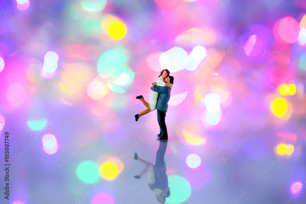 Miniature people : couple  in love and hugging over with bokeh background,love concept.