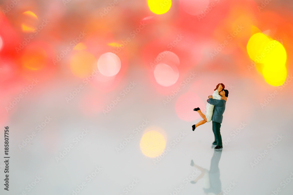 Miniature people : couple  in love and hugging over with bokeh background,love concept.