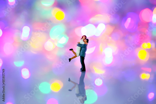 Miniature people : couple in love and hugging over with bokeh background,love concept.