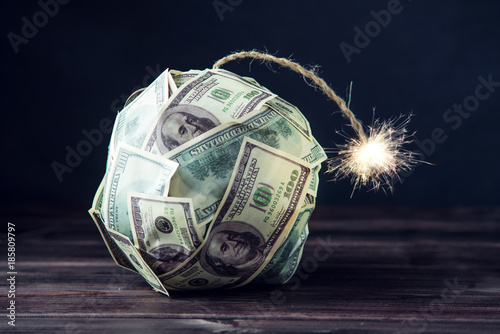 Slika na platnu Bomb of money hundred dollar bills with a burning wick