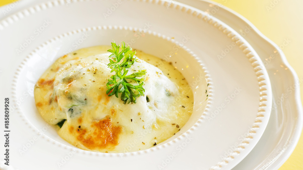 Baked Spinach with Cheese on a white plate.