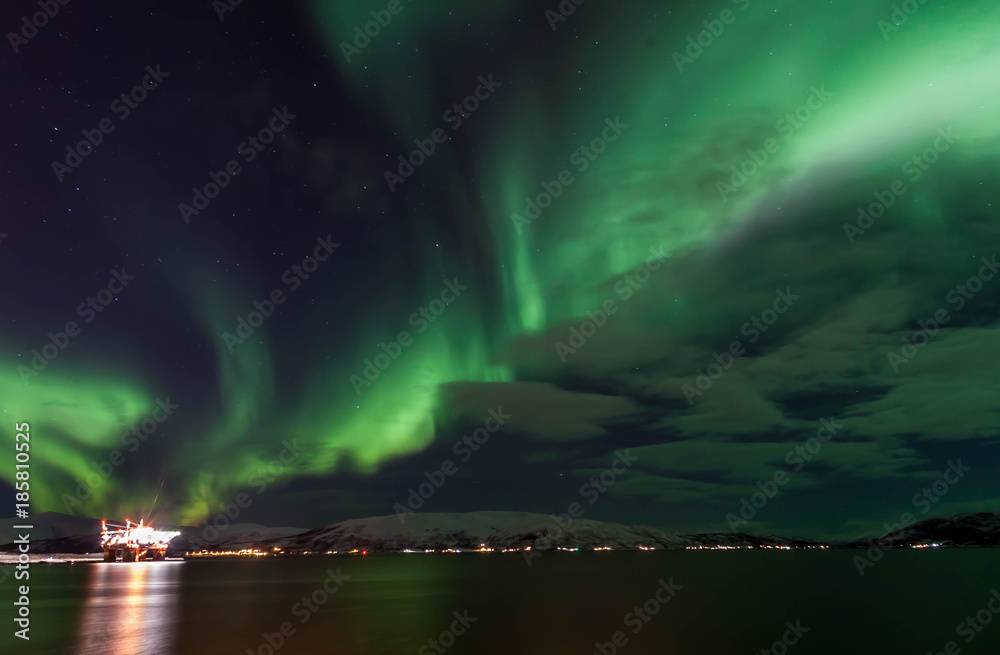 Amazing Aurora Borealis in North Norway above the sea, Tromso City