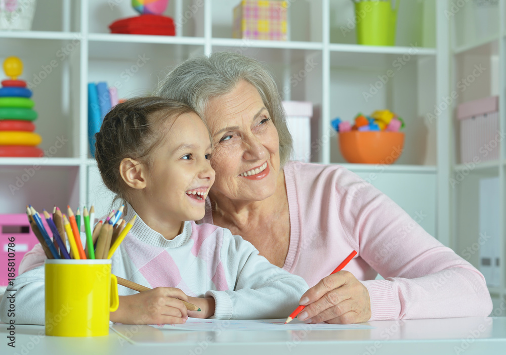 Fototapeta premium Grandmother with granddaughter drawing together