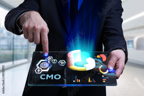 Business, Technology, Internet and network concept. Young businessman working on a virtual screen of the future and sees the inscription: CMO photo