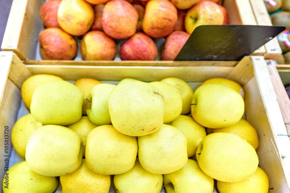 Fresh yellow and red apples with stickers in wood boxes for sale Fresh yellow and red apples with stickers in wood boxes for sale