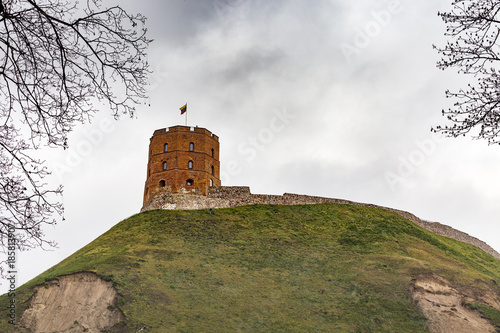 Gediminas' Tower with flag on hill in Vilnus, Lithuania. The hill has visible landslides or landslips