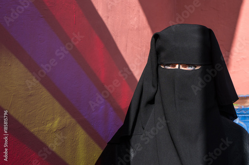 Arab woman with face covered with black niqab photo