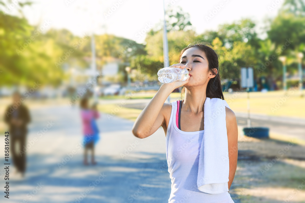 A women is exercising and relaxing at the park. A women is exercising and relaxing at the park.