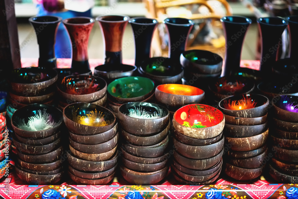 Coconut shell bowls on the wooden shelf. Souvenir coconut bowls selling on the market