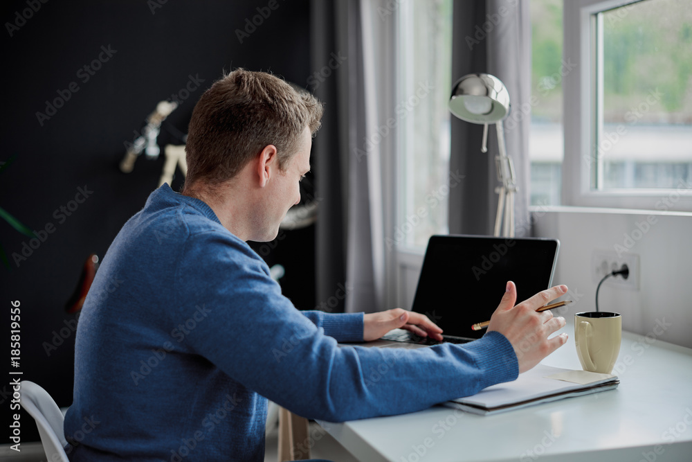 Businessman sitting in modern office and using laptop for work Businessman sitting in modern office and using laptop for work