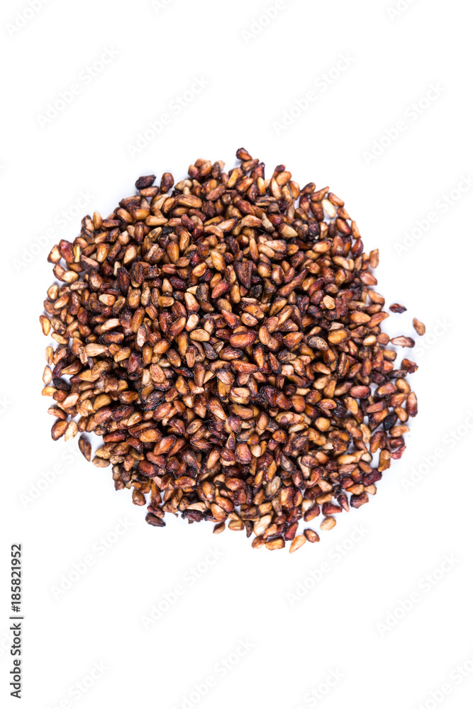 Pile of dried pomegranate seeds isolated on a white background