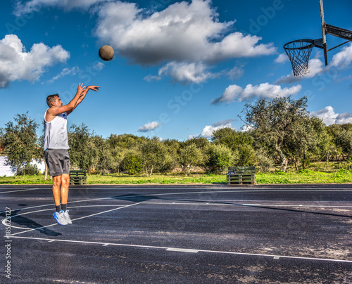 Side view of a lefty basketball player jump shot