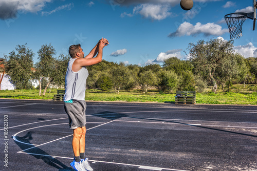 Basketball player shooting the ball © Gabriele Maltinti