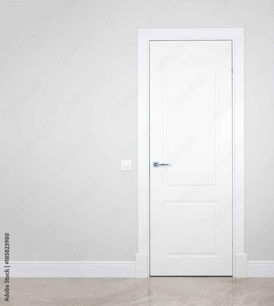 Fototapeta premium Modern white door. Grey wall with free space. Minimalist bright interior