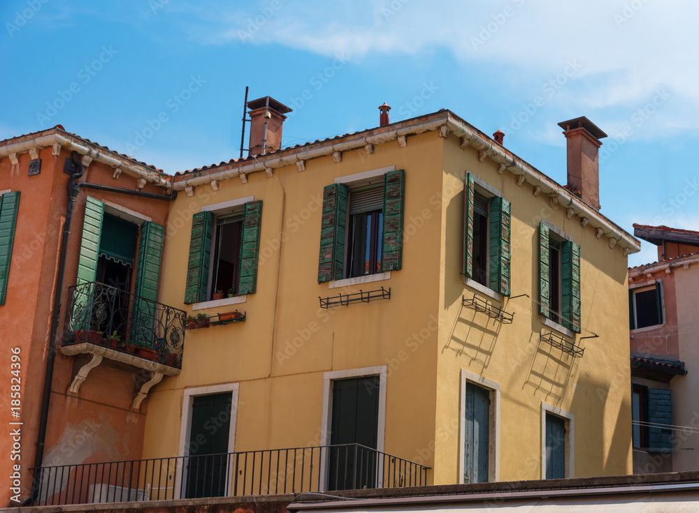 VENICE, ITALY – MAY 23, 2017: Traditional beautiful venetian houses in a sunny summer day. VENICE, ITALY – MAY 23, 2017: Traditional beautiful venetian houses in a sunny summer day.